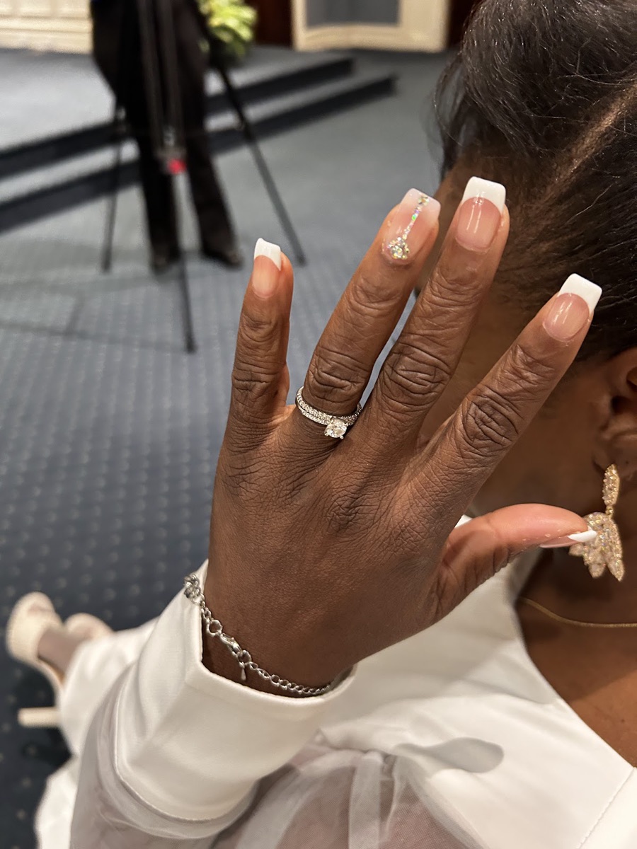 Long white French-tip nails with a sparkling glitter accent nail